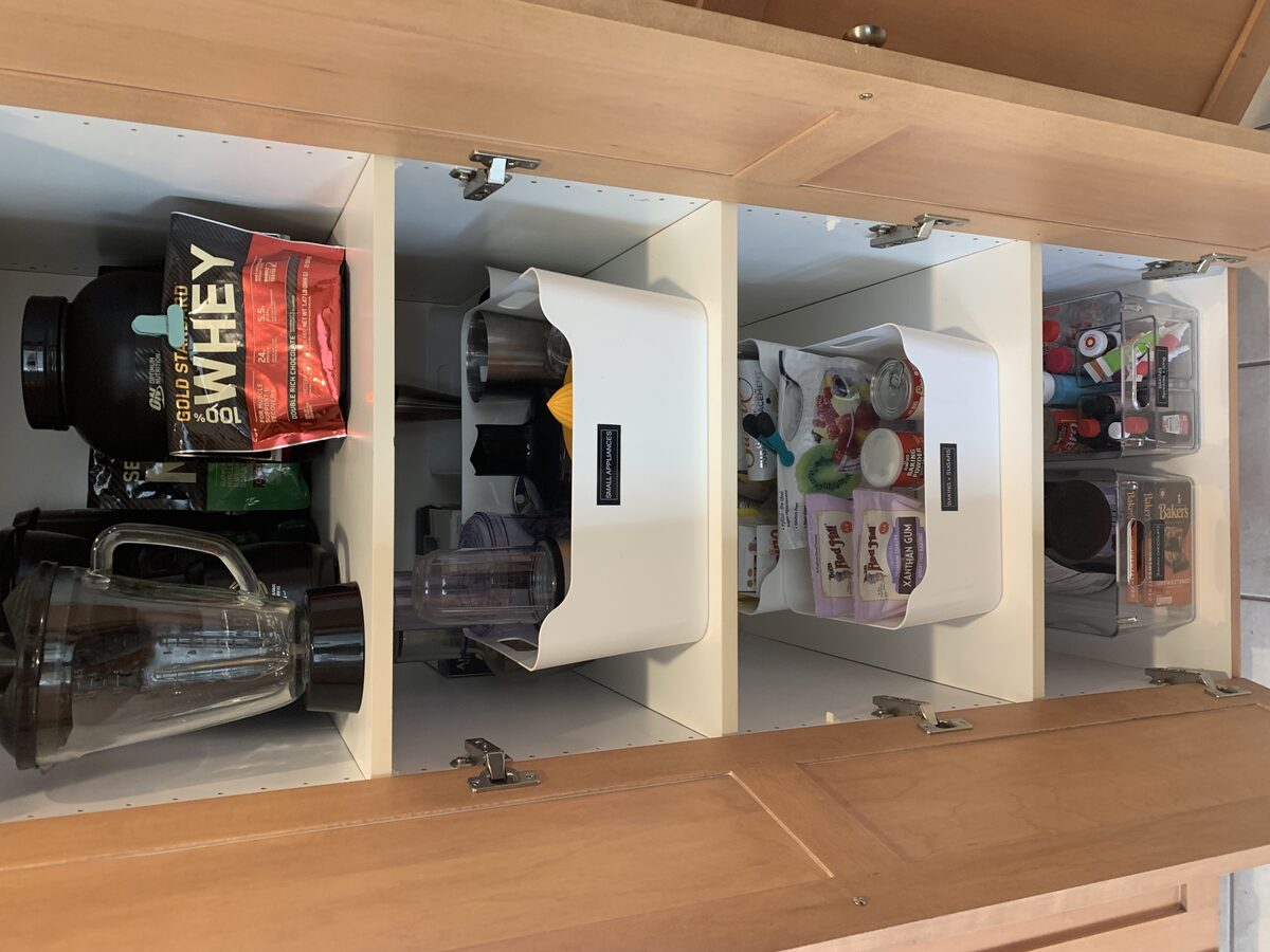 Deep pantry cabinet organized by category with front-facing labels — Simply Spacial Sarasota