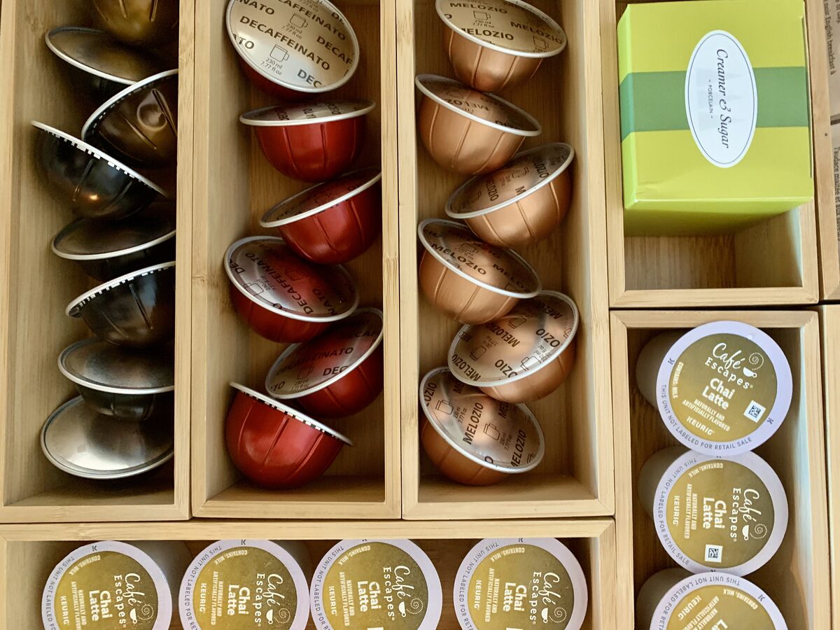 Home coffee station with pods, mugs, and supplies arranged for a streamlined morning routine — Simply Spacial Sarasota FL