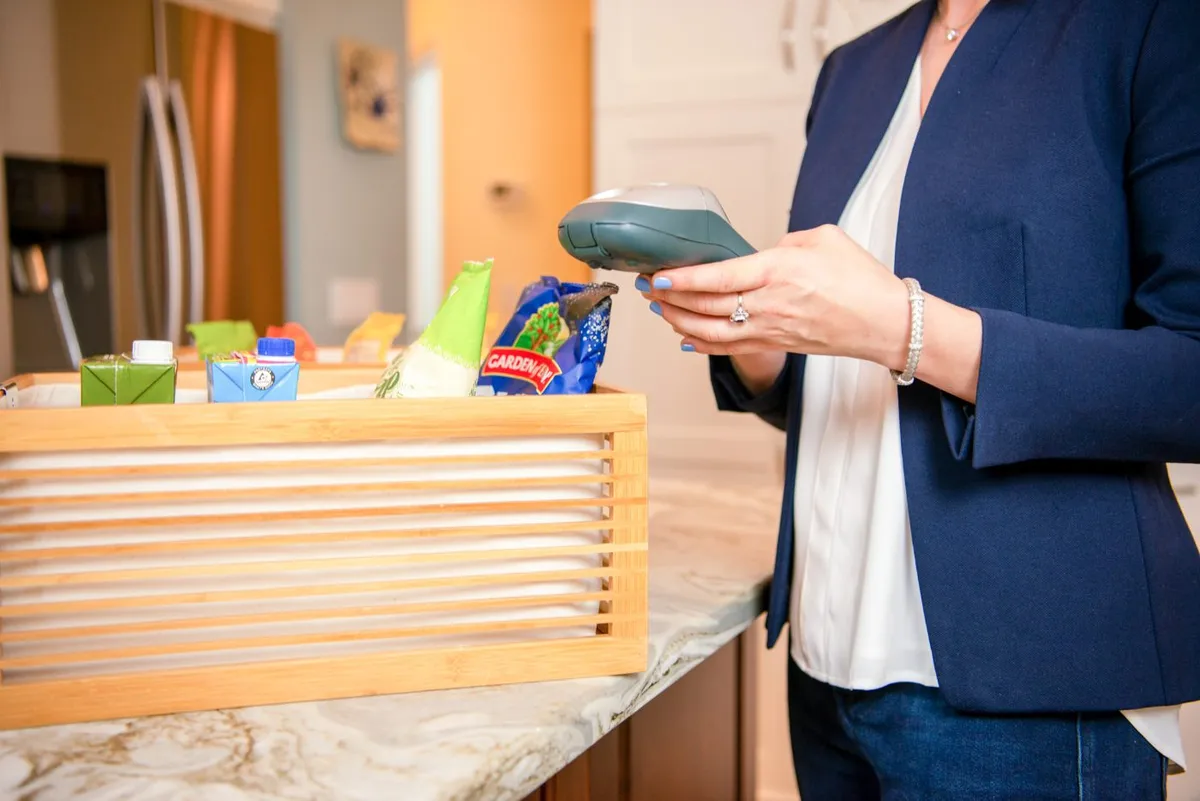 Kim photographing a pantry shelf